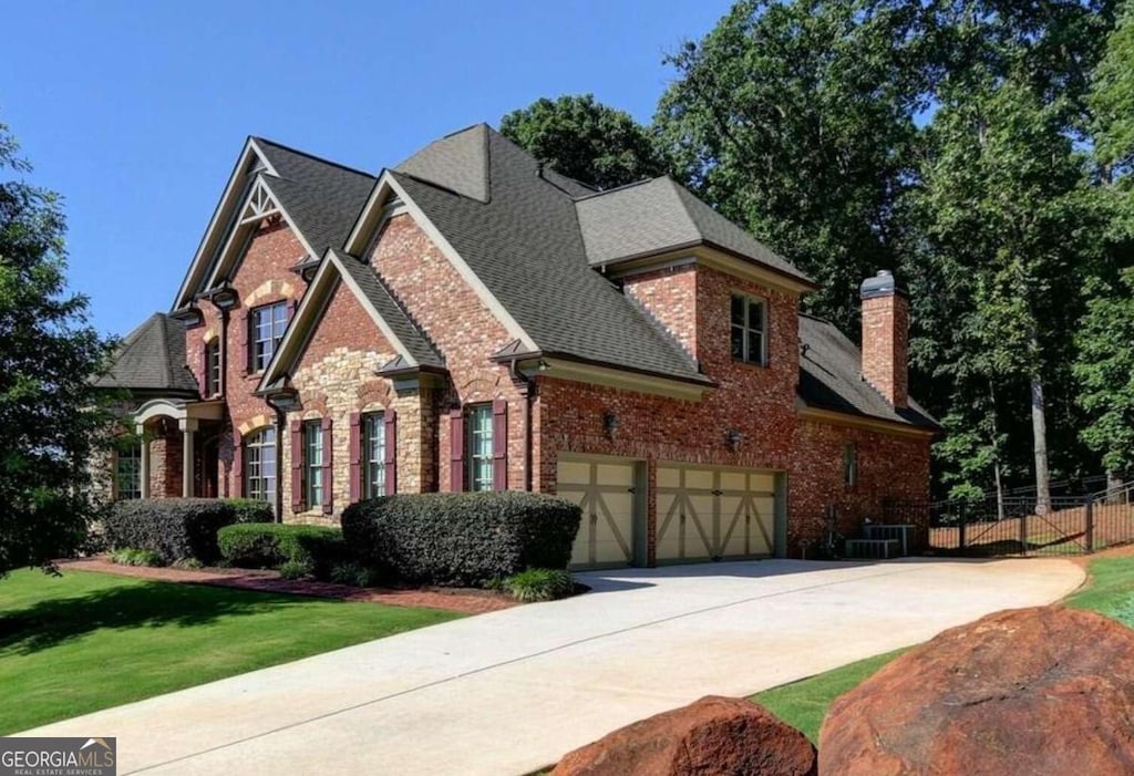 view of front of home featuring central AC and a garage