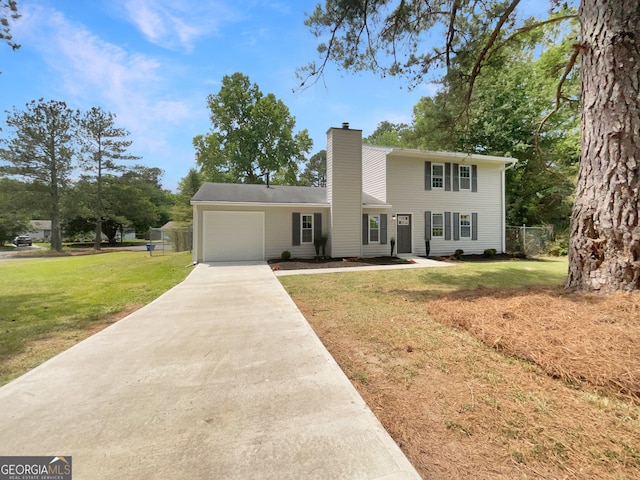 view of front of home with a garage and a front yard