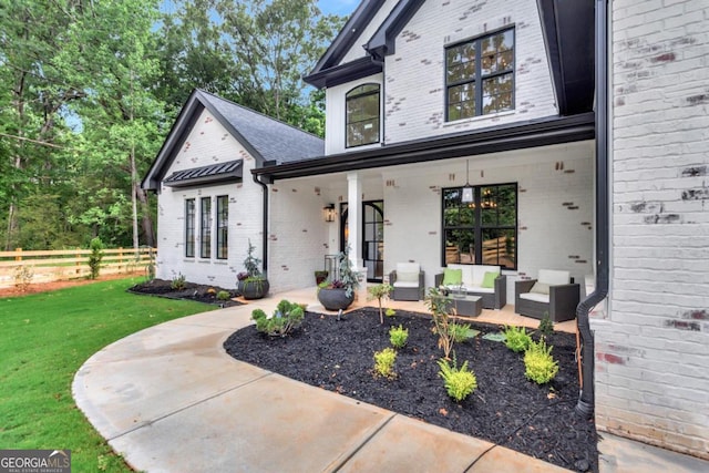 view of front of property with an outdoor living space and a front yard