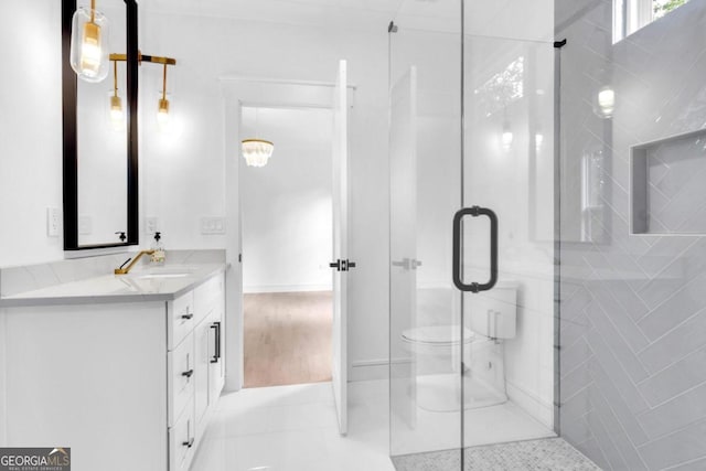 bathroom featuring wood-type flooring, vanity, toilet, and an enclosed shower