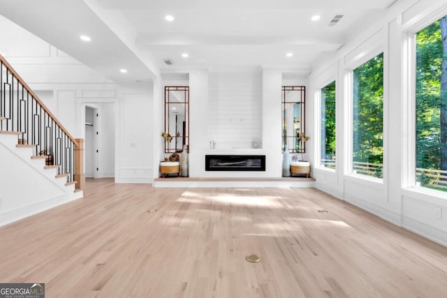 unfurnished living room featuring a fireplace and light wood-type flooring