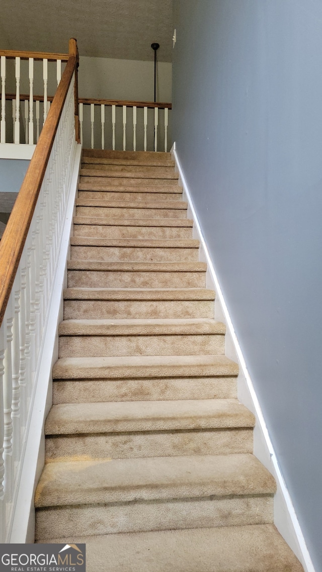 staircase with carpet flooring