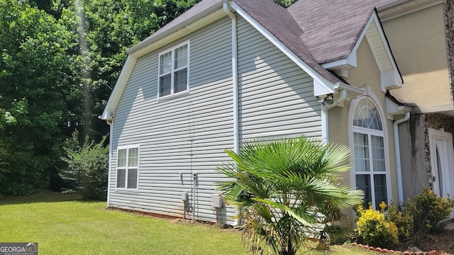 view of home's exterior featuring a yard