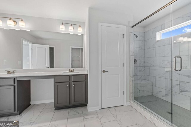 bathroom with a shower with door and vanity