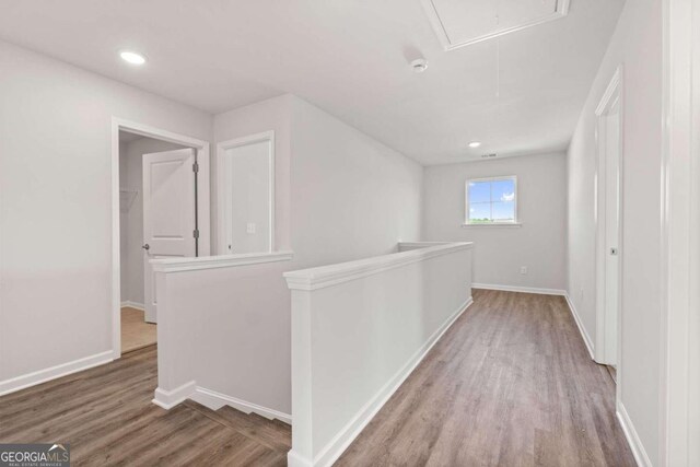 hallway with hardwood / wood-style floors