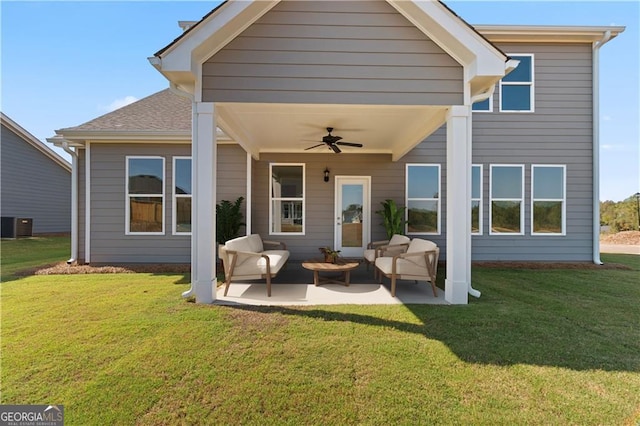 rear view of property featuring cooling unit, an outdoor living space, a lawn, a patio, and ceiling fan