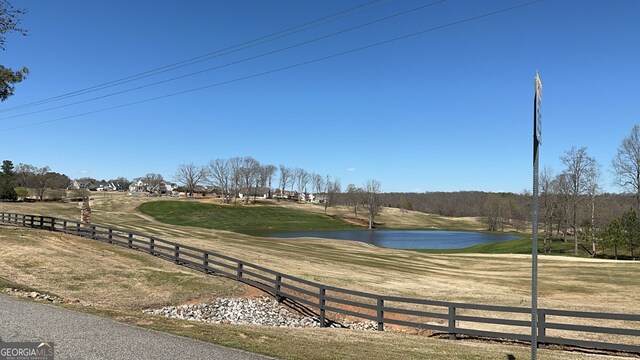 view of community with a yard and a water view