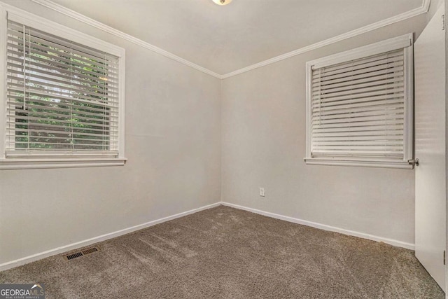 unfurnished room with carpet floors and crown molding