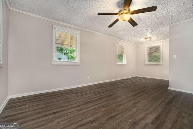 empty room with plenty of natural light, crown molding, a textured ceiling, and dark wood-type flooring