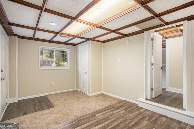 unfurnished room with hardwood / wood-style floors and coffered ceiling