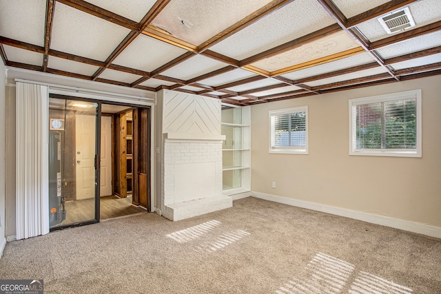 interior space with carpet, a textured ceiling, a brick fireplace, and coffered ceiling