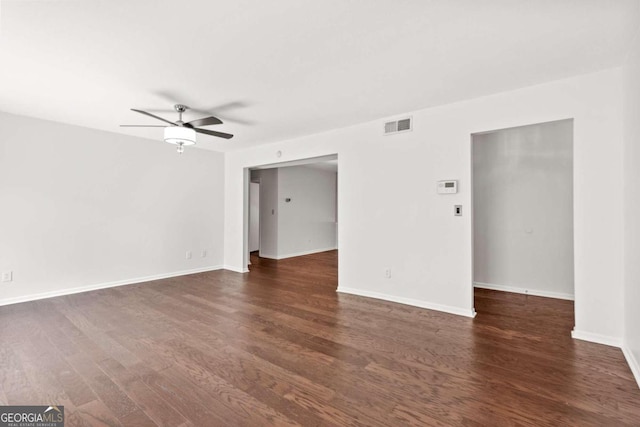 empty room with ceiling fan and dark hardwood / wood-style flooring