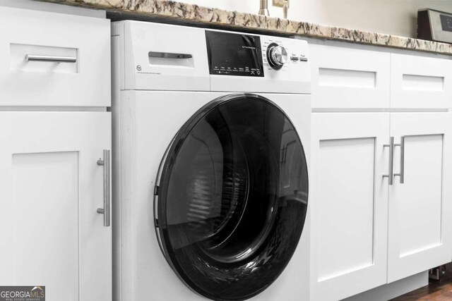 laundry area with cabinets and washer / dryer