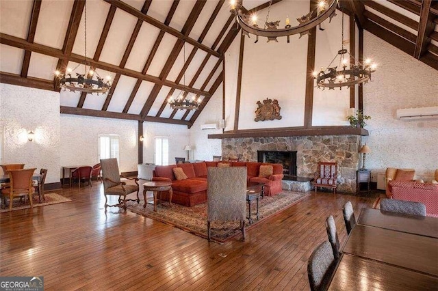 living room with hardwood / wood-style flooring, beam ceiling, a stone fireplace, and high vaulted ceiling