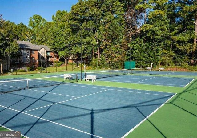 view of tennis court featuring basketball court