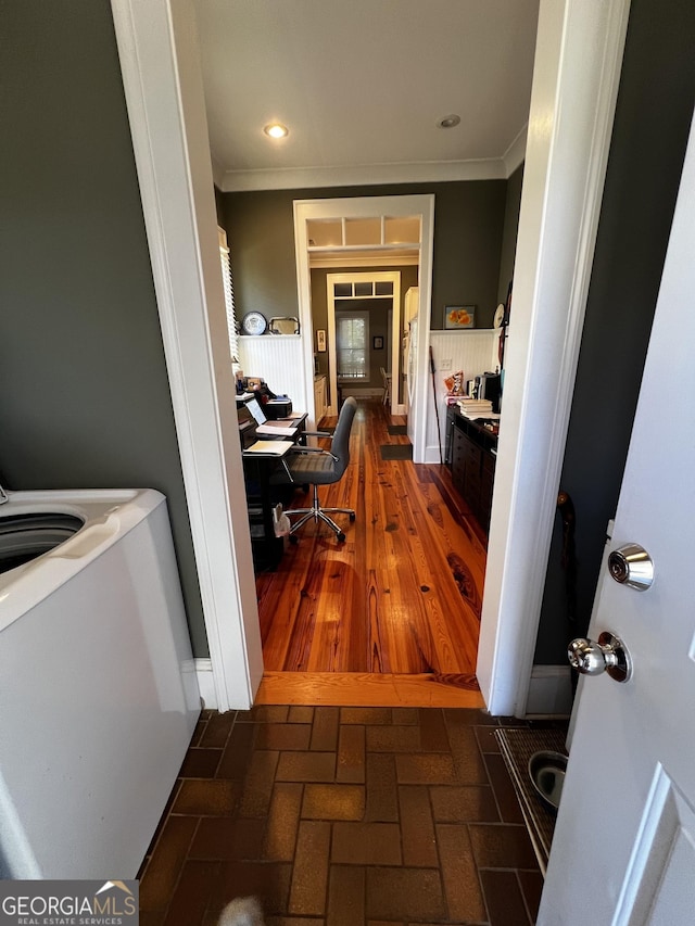 corridor with dark hardwood / wood-style floors and crown molding