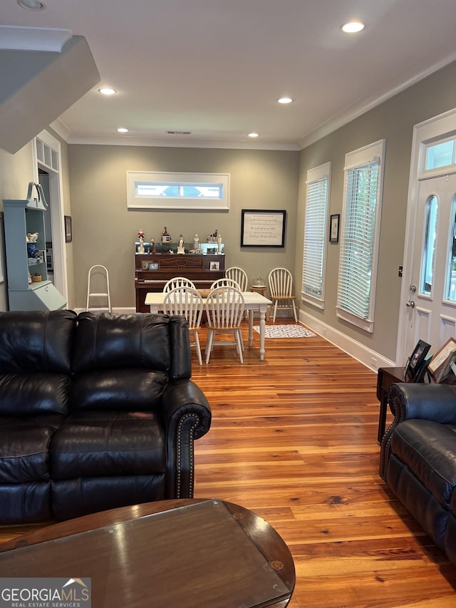 living room with hardwood / wood-style floors and ornamental molding