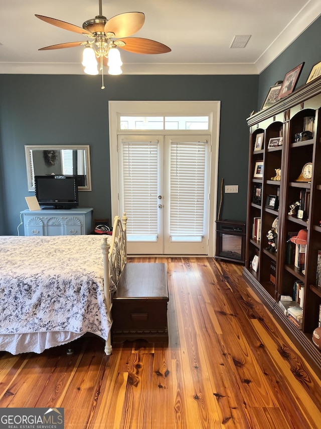 bedroom with french doors, dark hardwood / wood-style floors, ceiling fan, and crown molding