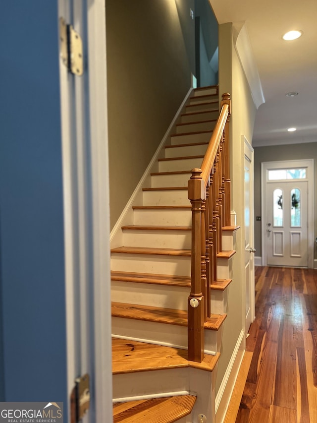 stairs featuring hardwood / wood-style floors