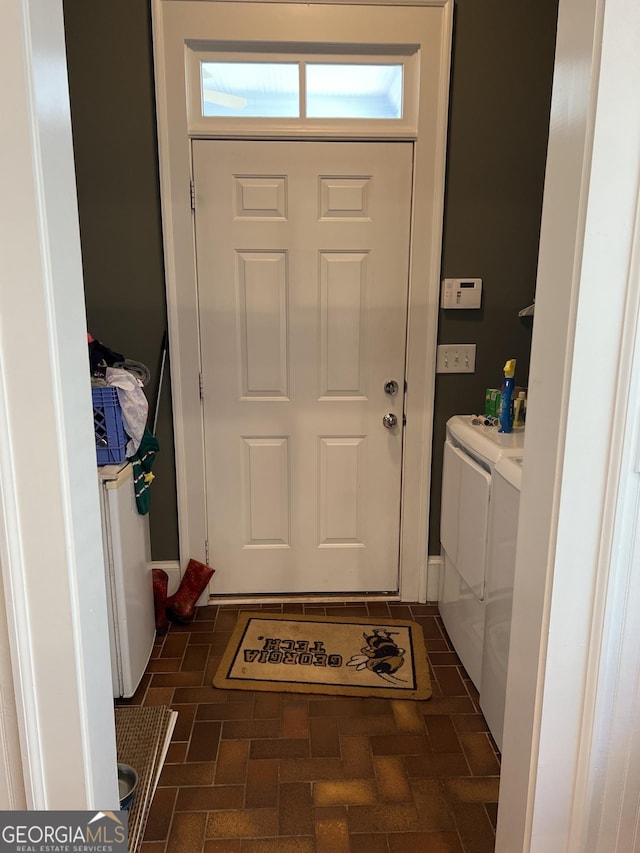 doorway to outside featuring separate washer and dryer