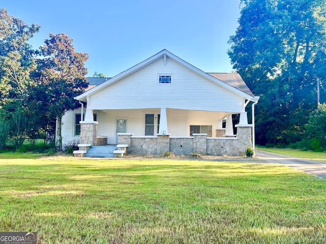 view of front of home with a front yard and a porch