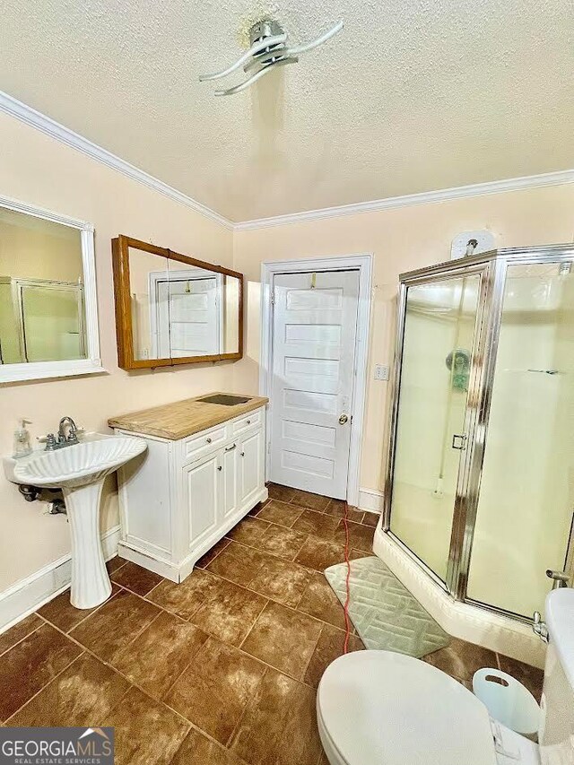 bathroom featuring an enclosed shower, ornamental molding, and tile patterned floors