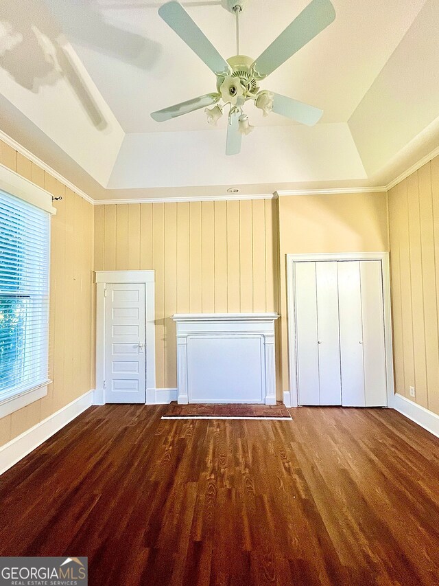 unfurnished bedroom with a raised ceiling and hardwood / wood-style flooring