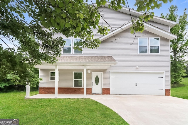 view of property featuring a front yard and a garage