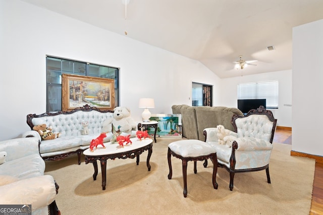 living room featuring ceiling fan, lofted ceiling, and light hardwood / wood-style floors