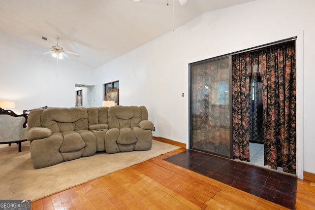 living room with wood-type flooring, ceiling fan, and vaulted ceiling