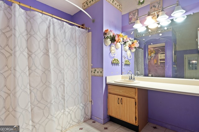 bathroom with vanity, tile patterned floors, and a textured ceiling