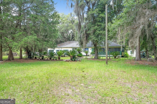 view of yard featuring a sunroom