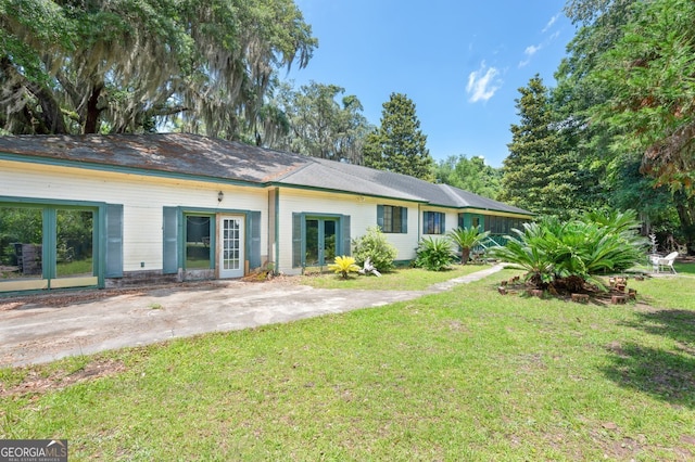 back of house with a lawn