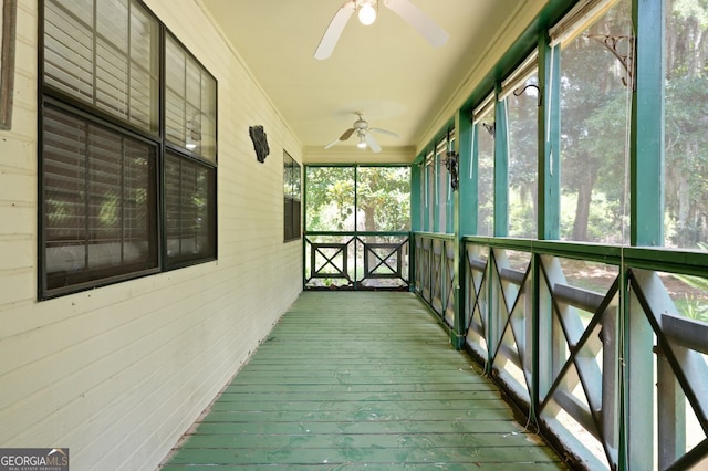 unfurnished sunroom featuring ceiling fan