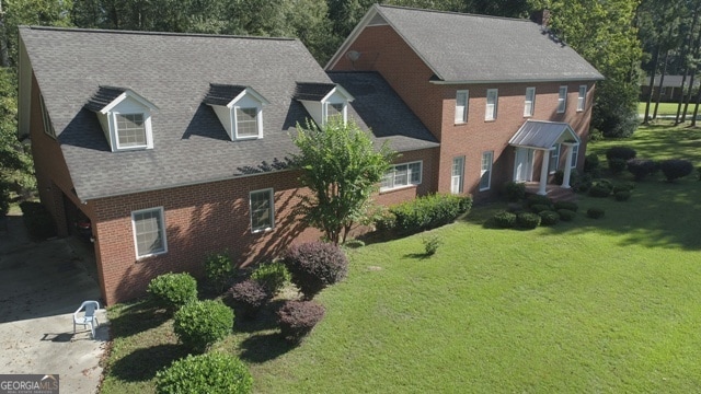 colonial inspired home with a front lawn