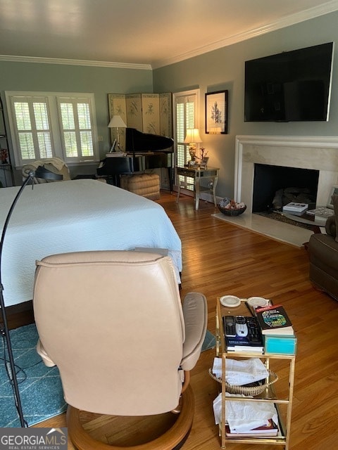 bedroom featuring hardwood / wood-style floors and ornamental molding