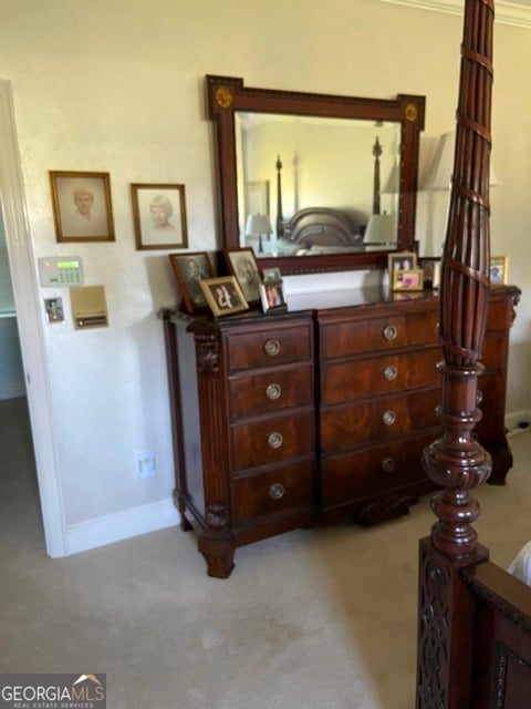 carpeted bedroom with ornamental molding