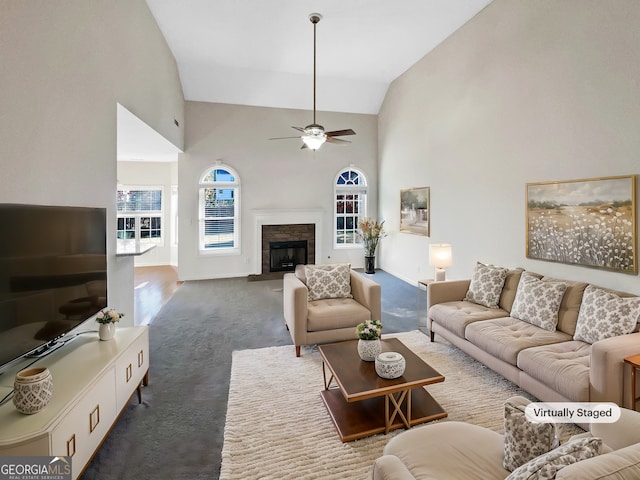 living room with ceiling fan, dark carpet, and high vaulted ceiling