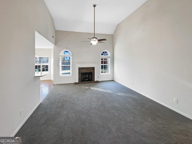 unfurnished living room featuring ceiling fan, high vaulted ceiling, and dark carpet