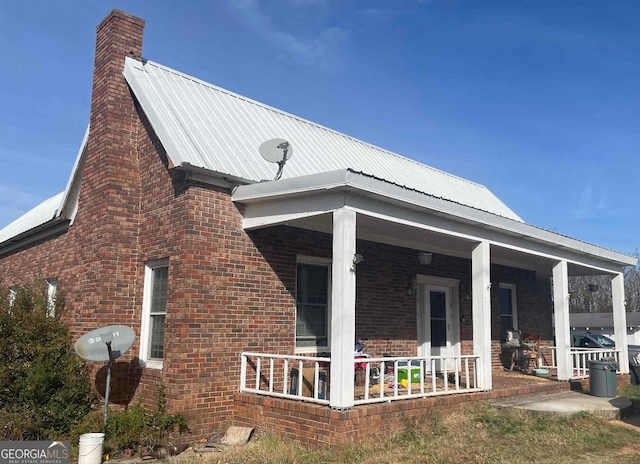 view of side of property with covered porch