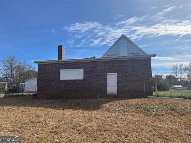 view of property exterior with a lawn