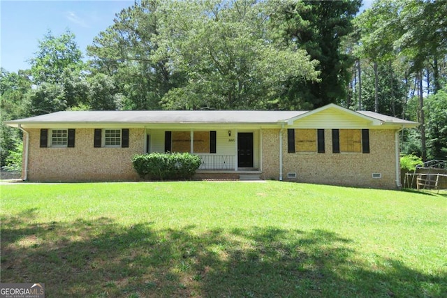 ranch-style home with a front yard and covered porch