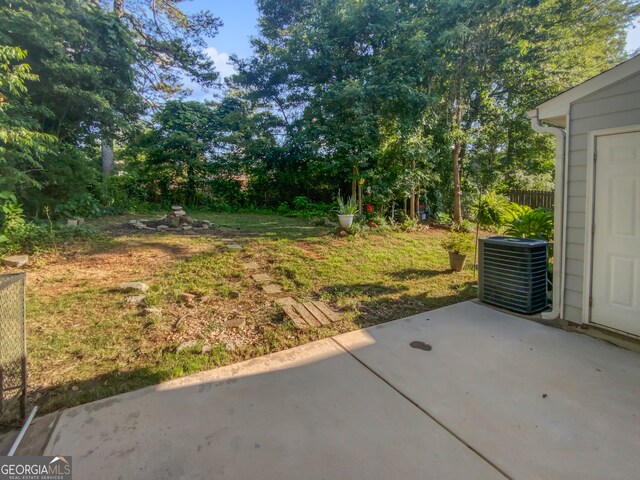 view of yard with a patio area and central air condition unit