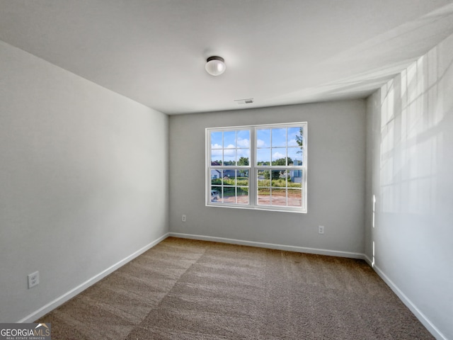 unfurnished room featuring carpet