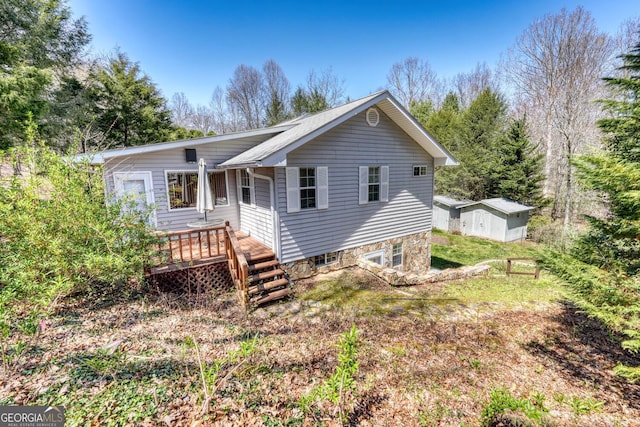 back of house featuring a wooden deck