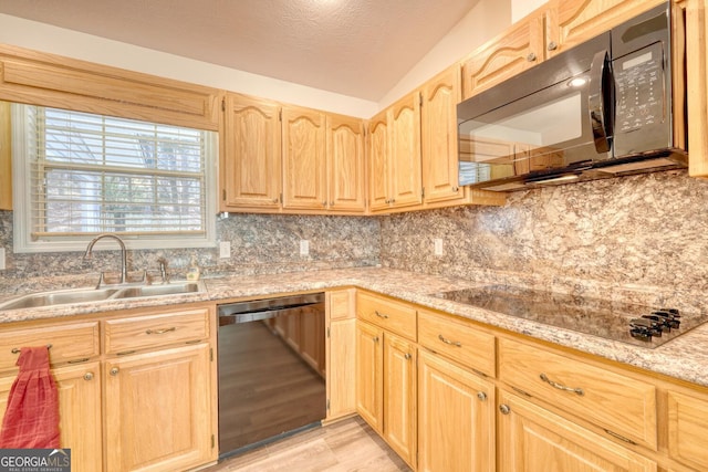 kitchen featuring sink, black appliances, and tasteful backsplash