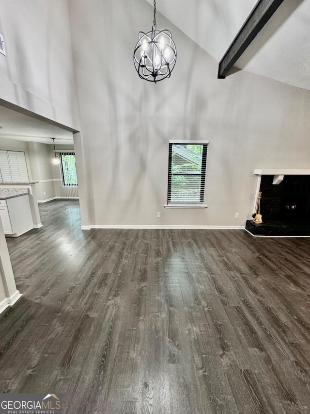 unfurnished living room featuring high vaulted ceiling, beam ceiling, and dark wood-type flooring