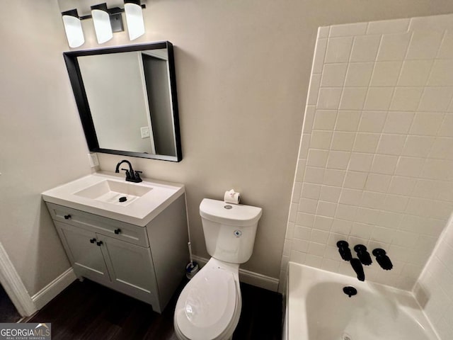 full bathroom featuring toilet, vanity, and tiled shower / bath