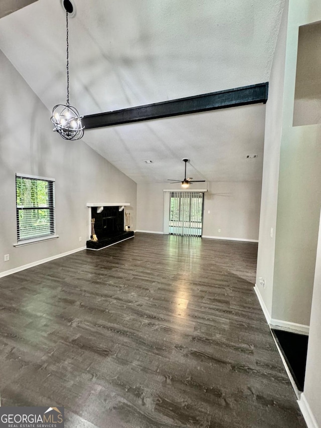 unfurnished living room with ceiling fan, lofted ceiling with beams, and dark hardwood / wood-style floors