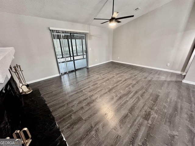 unfurnished living room featuring ceiling fan, dark hardwood / wood-style floors, and a textured ceiling